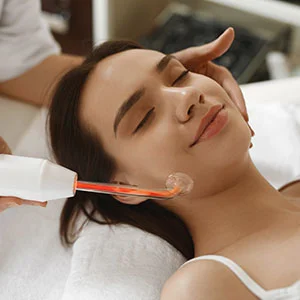 Woman receiving facial treatment