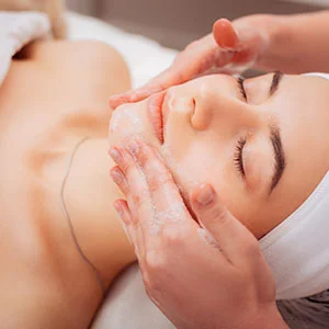 Woman receiving facial treatment