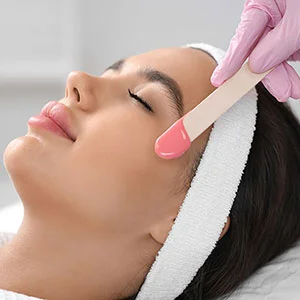 Woman receiving facial treatment