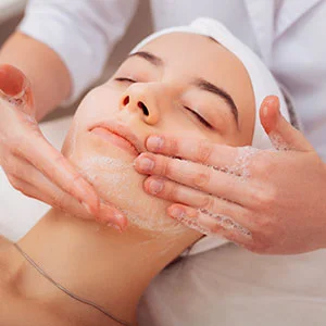 Woman receiving facial treatment