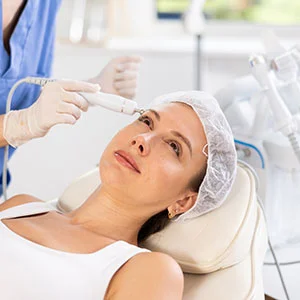 Woman receiving facial treatment