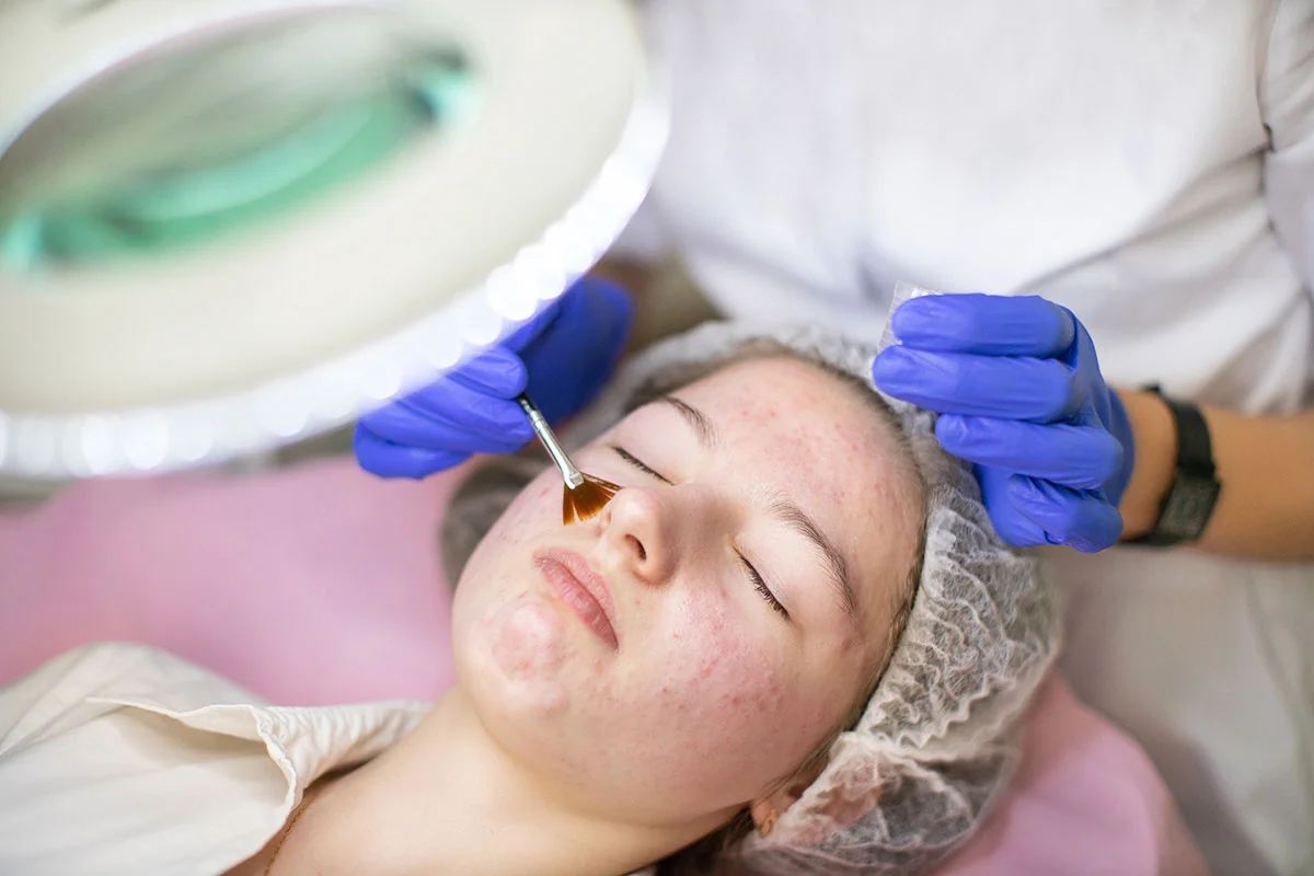 Woman receiving facial treatment