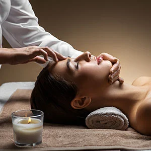 Woman receiving facial treatment