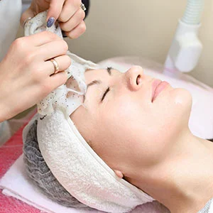 Woman receiving facial treatment