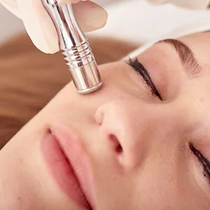 Woman receiving facial treatment