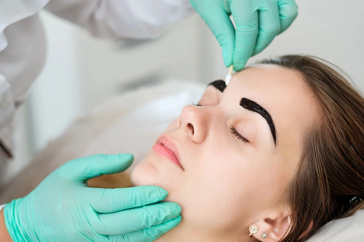 Woman receiving facial treatment
