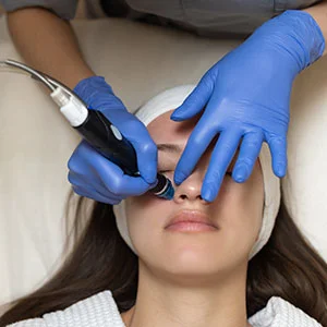 Woman receiving facial treatment