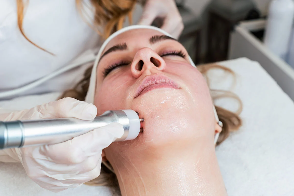 Woman receiving facial treatment