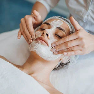 Woman receiving facial treatment