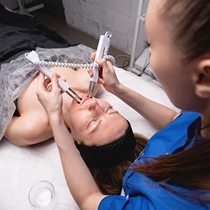 Woman receiving facial treatment