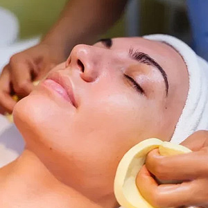Woman receiving facial treatment