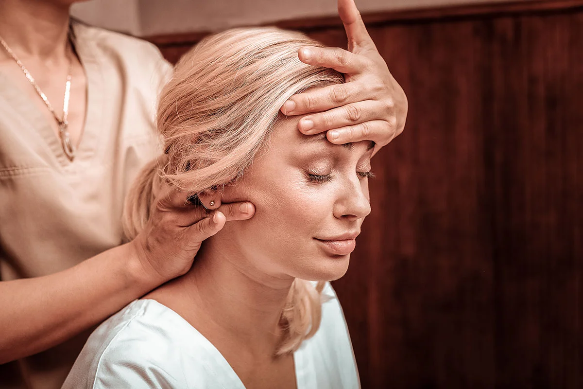 Woman receiving facial treatment