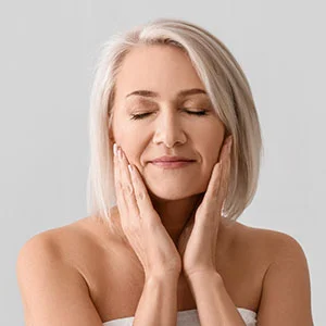 Woman receiving facial treatment