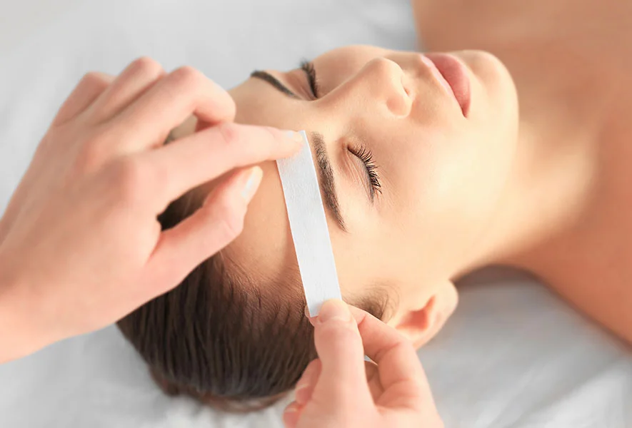 Woman receiving facial treatment