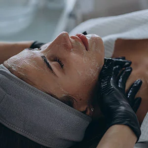 Woman receiving facial treatment