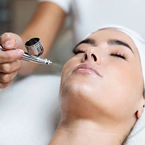 Woman receiving facial treatment