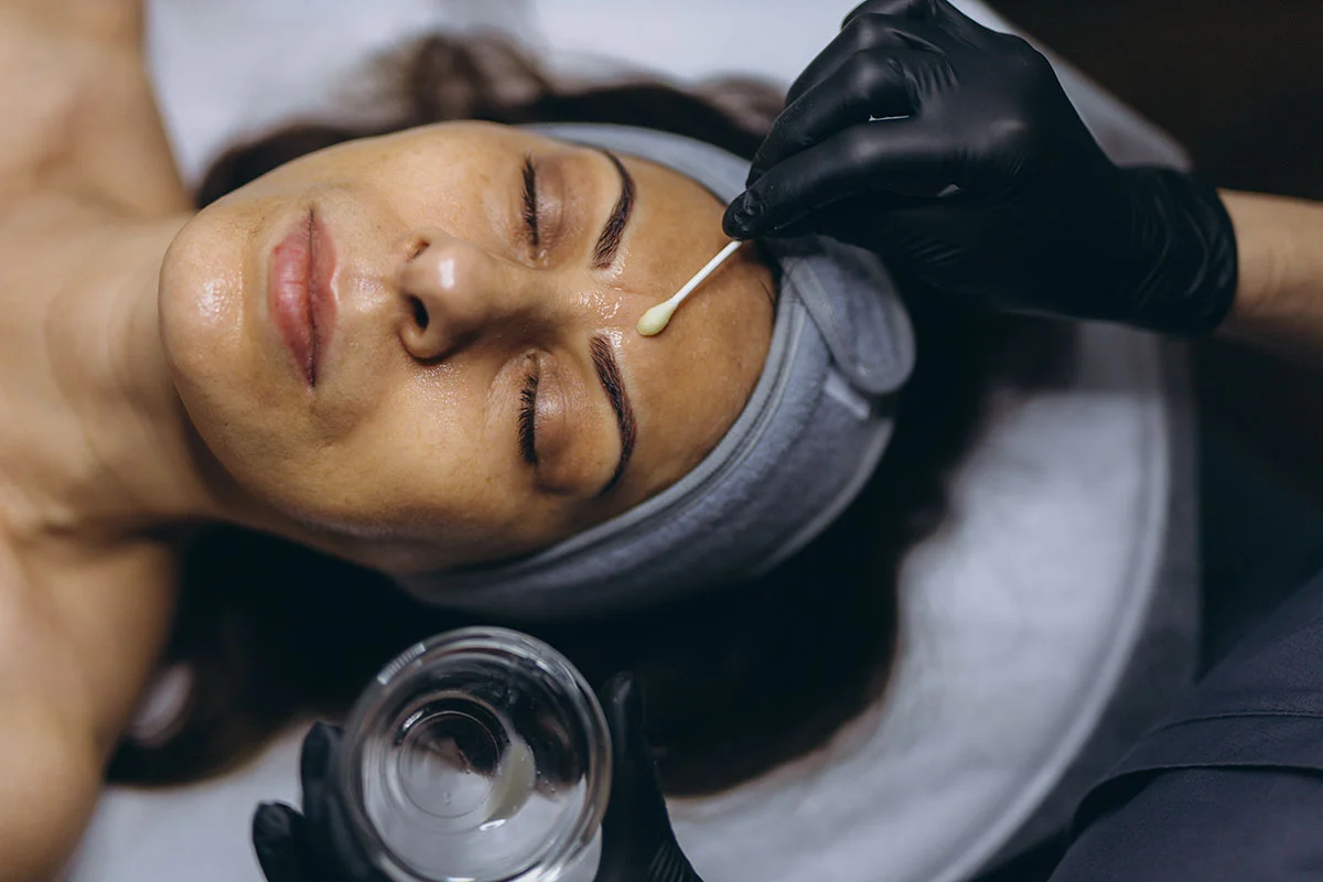 Woman receiving facial treatment